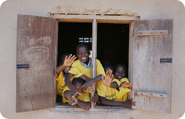school children smiling from window