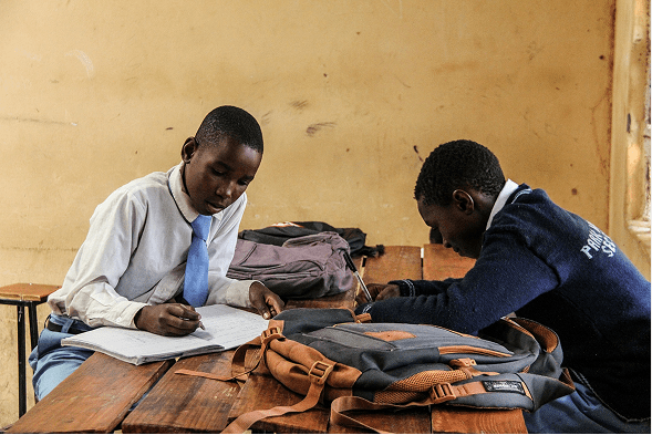 two student writing in class