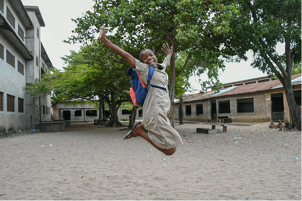 female pupil jumping while smiling