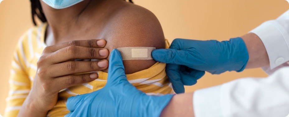 Close-up of a person's hand with a medical plaster after receiving treatment, showcasing the World Malaria Day 2026 impact Africa in rural clinics.