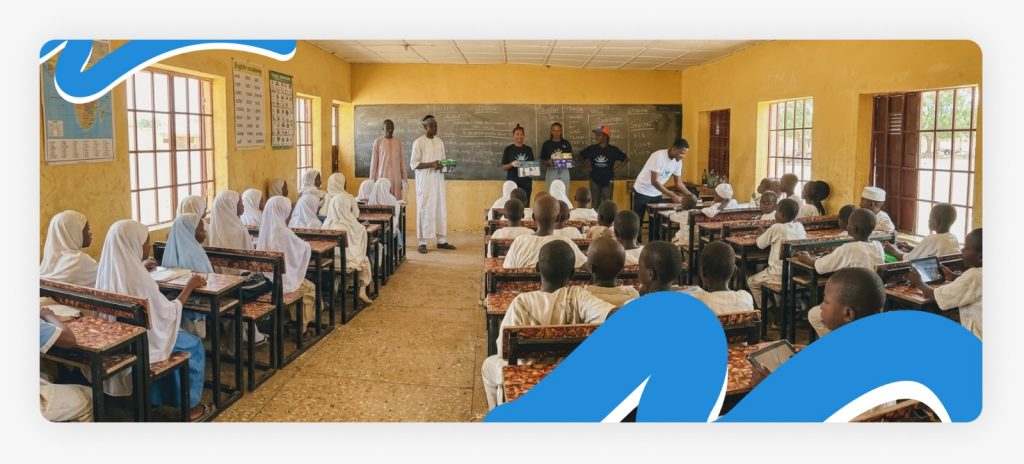 Better Life NGO outreach staff standing in front of the classroom addressing the kids as part of our mission of giving back to the community.