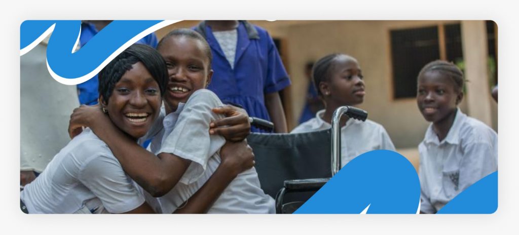 A young boy with physical disabilities sitting in an old wheelchair with a pitiful expression, highlighting the desperate need for support for physically challenged people in Africa in 2026.