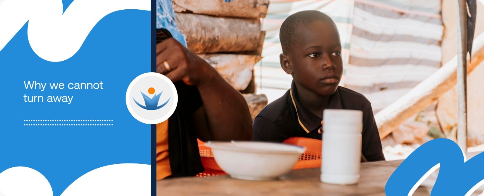 A young boy sitting quietly with empty plates in front of him, illustrating the urgent need for intervention for malnourished children in Africa.