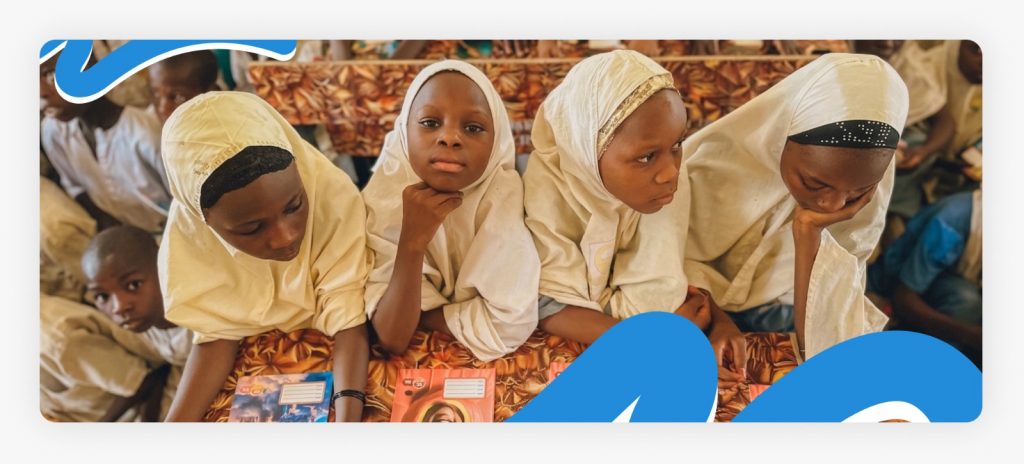 A group of primary school students sitting together with somber body language that highlights why they need continuous humanitarian aid for children in Africa.