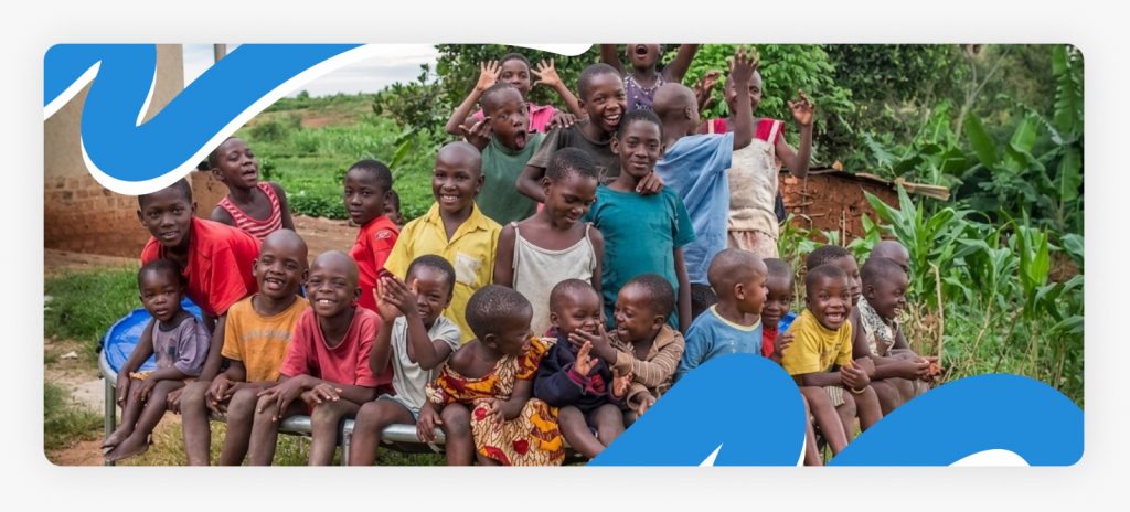 A happy group of orphanage children taking a picture pose together, with some smiling as they experience hope through learning in Africa’s underserved communities.