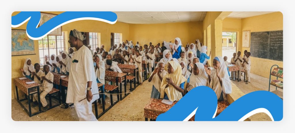 Primary school students and their teacher working together inside a classroom, highlighting the strategic improvement in study classes for african suffering children.