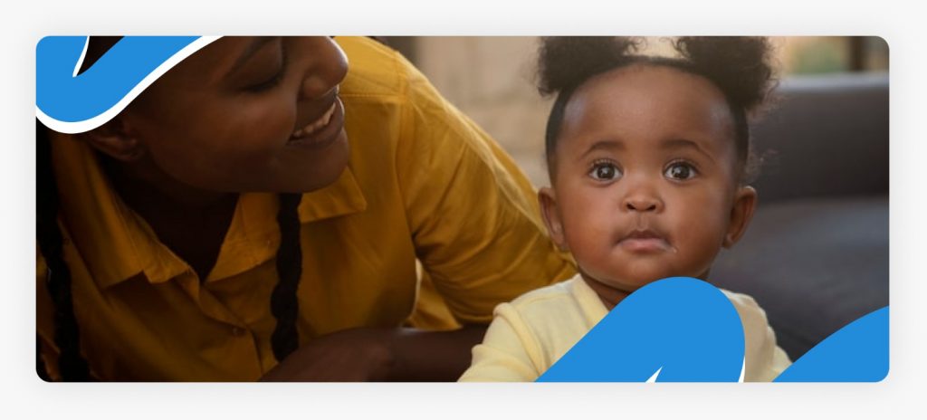 A joyful mother smiling while holding her healthy toddler, demonstrating the life-saving impact of support for orphaned babies in Africa and community foster care programs in 2026.