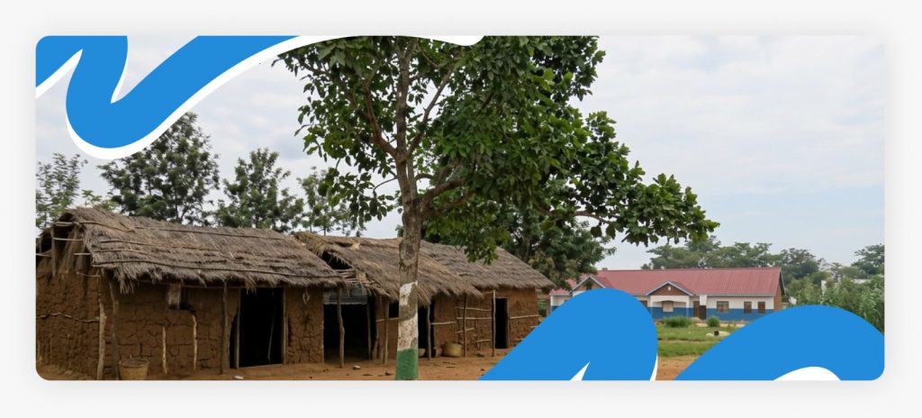 A remote rural community with traditional mud houses, showcasing the impoverished living conditions where children face severe barriers to basic education.
